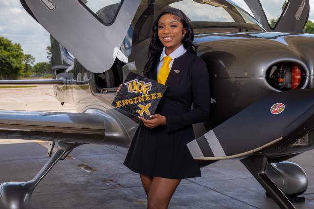 Asia Stanford posing with airplane