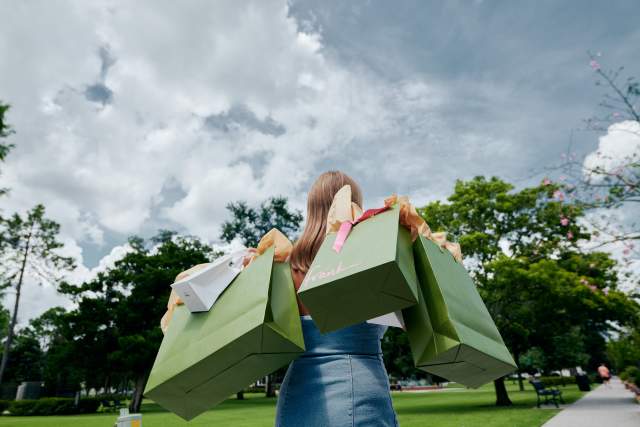 A woman holding shopping bags from Frank store in Winter Park
