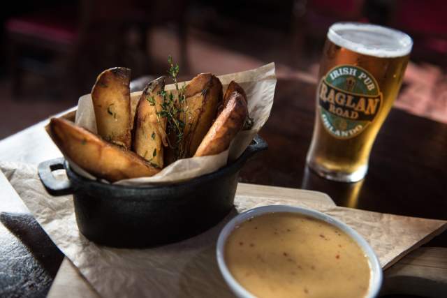 Basket of fries and a glass of beer at Raglan Road Irish Pub