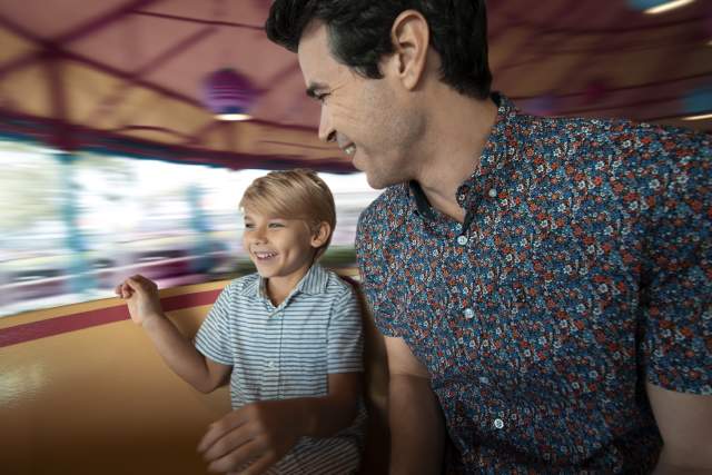 A father and son on the Mad Tea Party ride at the Magic Kingdom in the Walt Disney World Resort.