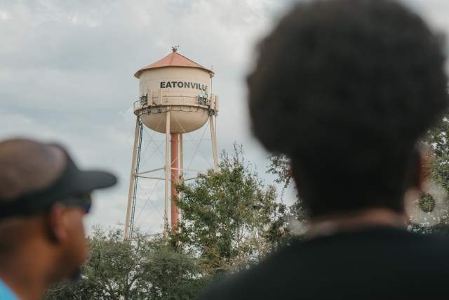 Two people look at the community water tower in the Historic Town of Eatonville near Orlando.