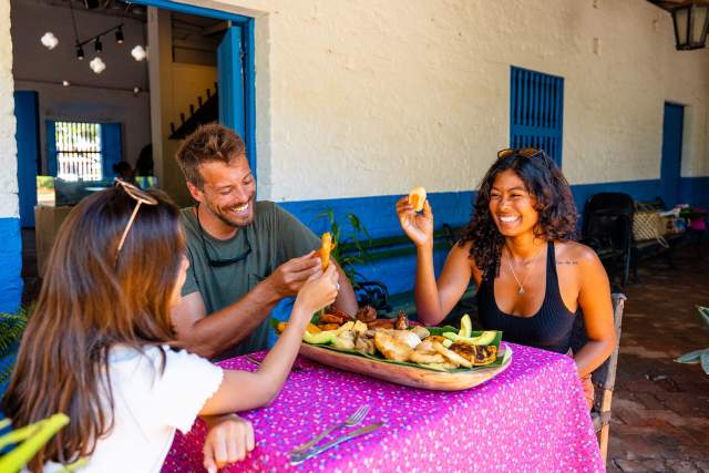 Friends eating Panamanian dish at La Villa de los Santos, Los Santos Province, Panamá