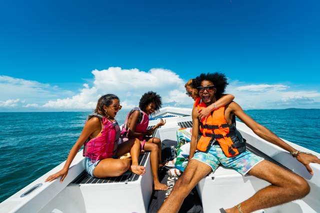 Friends enjoying a beautiful sunny day on a boat on the beaches of the Gulf of Chiriqui
