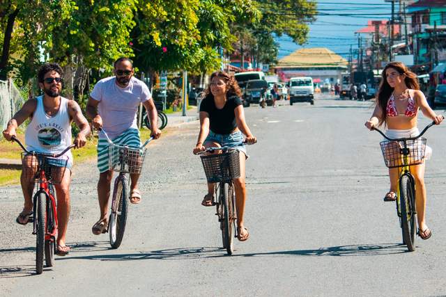 Group biking on the streets of Colon Island, Bocas del Toro
