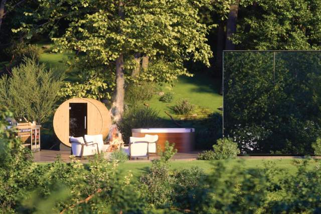 A sitting area and outdoor sauna next two a mirrored structure in the woods