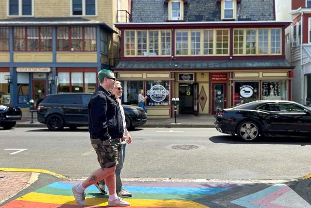 Couple walks across a crosswalk in a small town