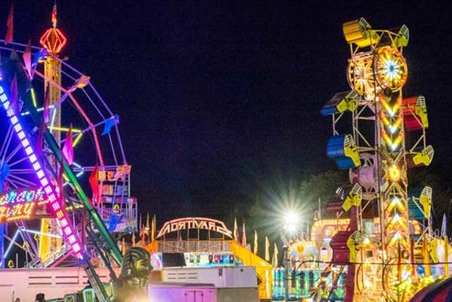 Carnival rides lit up at night