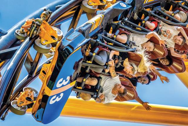 People on a roller coaster that's twisting in the air