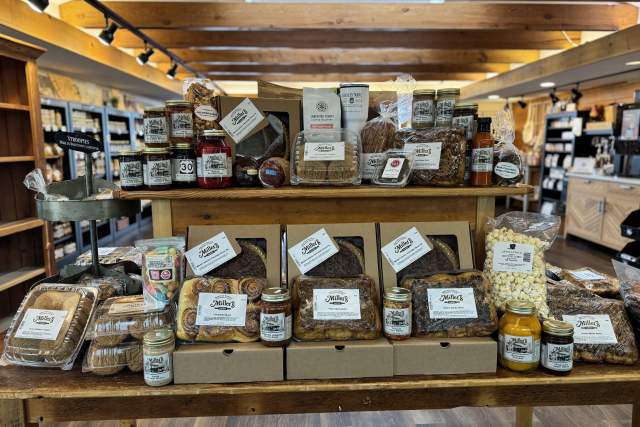 A display table in a store with pastries and pies placed on it for sale