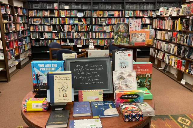 Table display in a bookstore in front of shelves of books at Otto's Bookstore in Williamsport