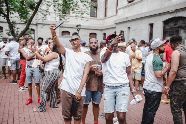 Groups of people gathering around and taking selfies with one another