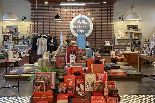 Table display of books to buy in front of a coffee counter