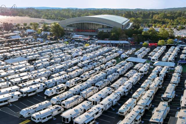 Aerial of hundreds of RVs lined up in lines in a parking lot