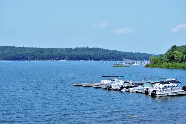 A scenic lake with boats parked on a dock
