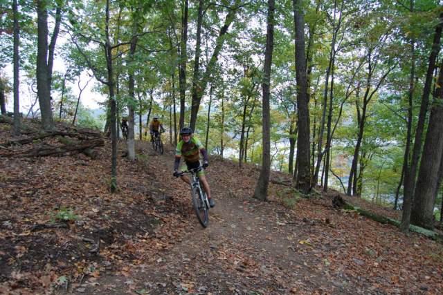 A person biking through woods