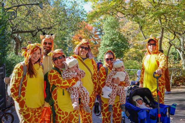 Two families dressed up in giraffe costumes