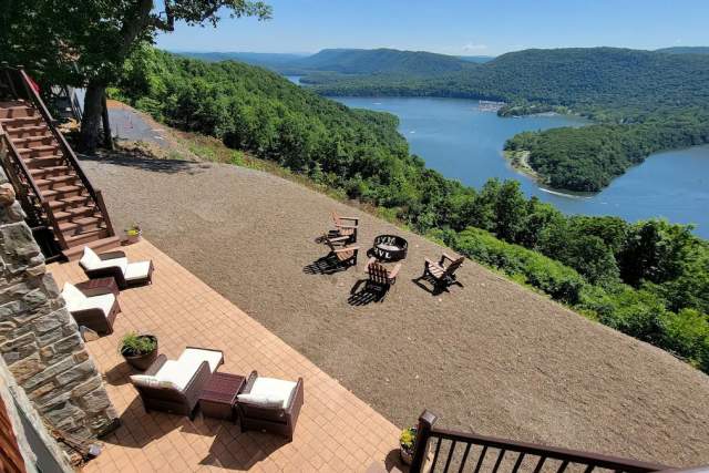 Aerial view of a porch with chairs at a cabin looking over a lake