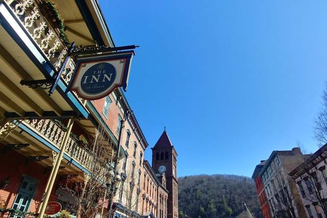 A main street of a downtown with storefronts and a prominent sign that reads The Inn at Jim Thorpe