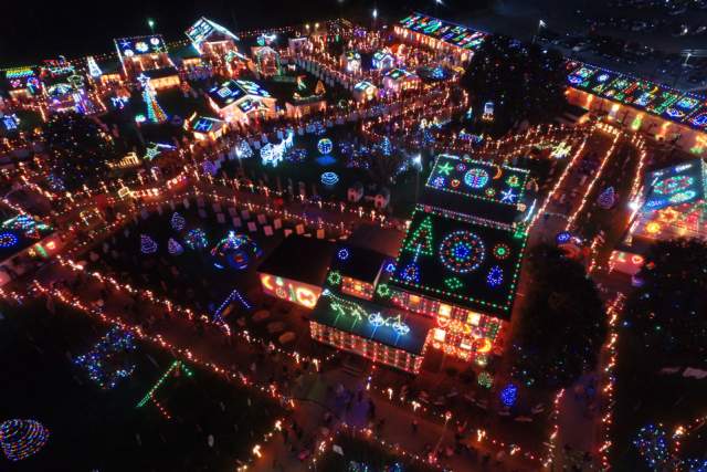 Aerial of a light display at night covering a mansion and the land surrounding it