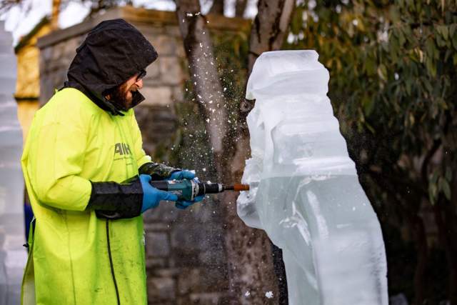 A person carving ice sculptor