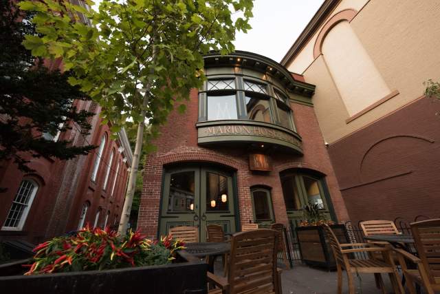 Exterior of a two-story, red brick restaurant with enlarged letters that read Marion Hose Co. N94