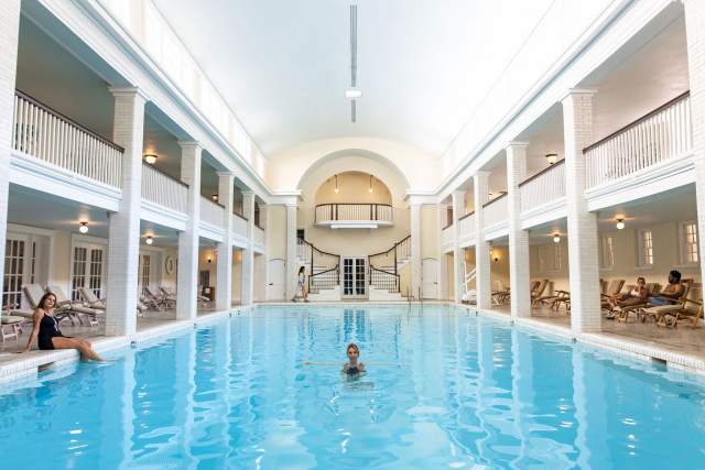 Woman swimming in the spa swimming pool at Omni Bedford Spring Resort and Spa