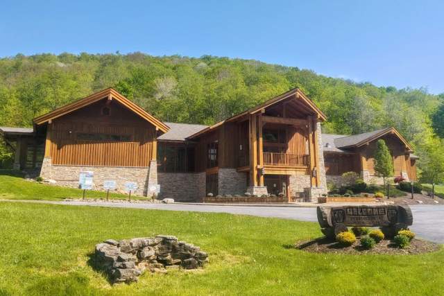 Exterior of a wooden museum in Wellsboro, PA with green mountains in the background