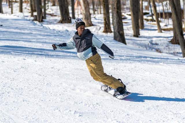 A person snowboarding down slope