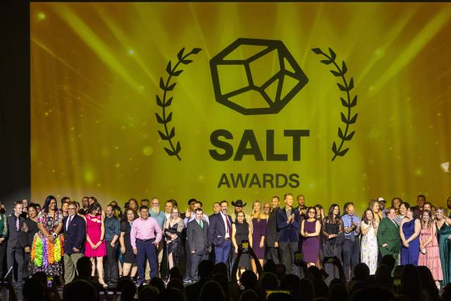 All of the 2025 Salt award nominees on stage with a golden yellow backdrop that says Salt Awards