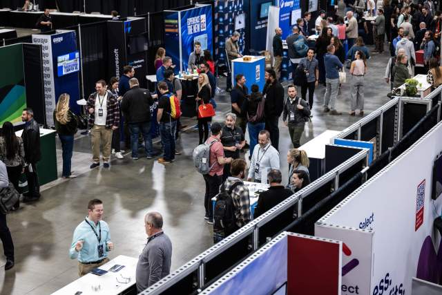 Aerial view of the connection corridor at summit 2026 with lots of people and booths