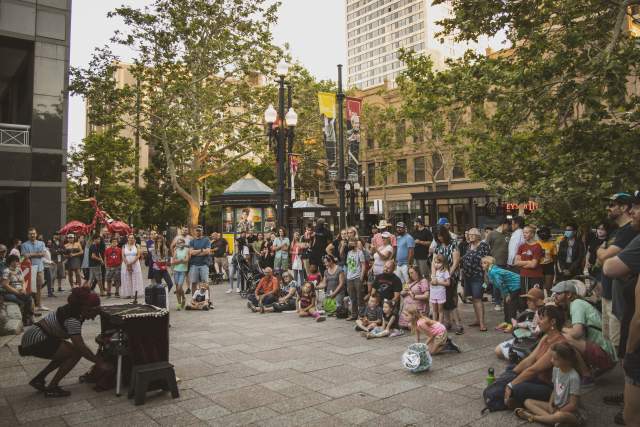 Crowd of people surrounding a performer on the streets of Salt Lake