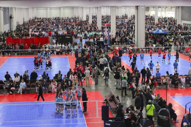 Volleyball courts inside a convention center with volleyball players