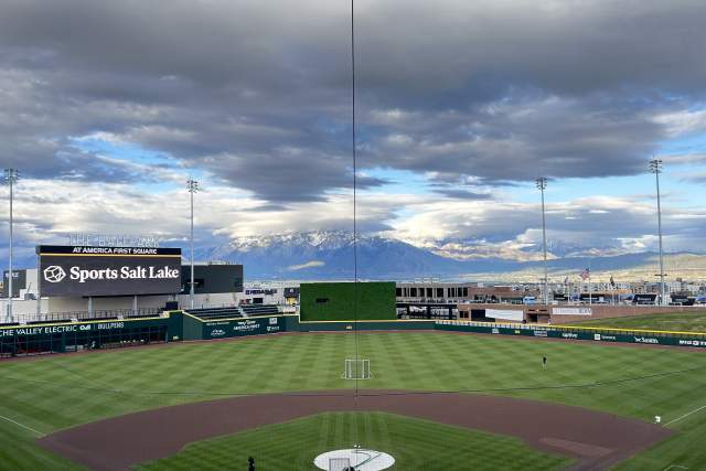 Baseball diamond with the Wasatch Mountains in the background and Sports Salt Lakeon the marquee