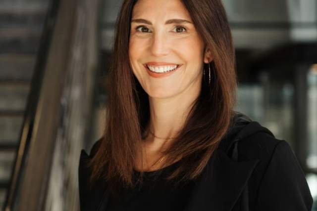 Smiling woman in black dress shirt
