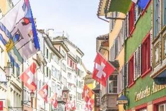 Colorful street in Zurich with flags and colorful buildings
