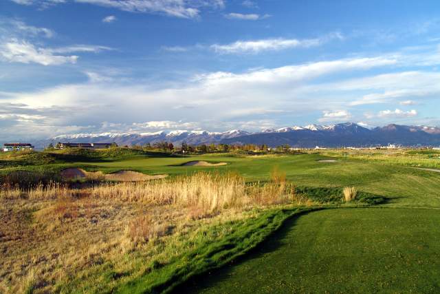 Golf course showing the rough next to a fairway with Salt Lake City and the Wasatch mountains in the background