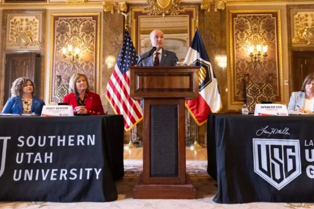 Utah govenour is at a podium making an announcement.