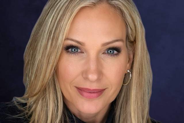 Headshot of slightly smiling woman