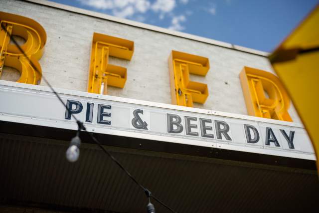 A store sign that says Beer with a marquee underneath that says Pie & Beer Day