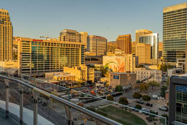 A view of downtown Salt Lake from the 6th floor of the Hyatt Regency. Buildings, one with a mural, bathed in golden light