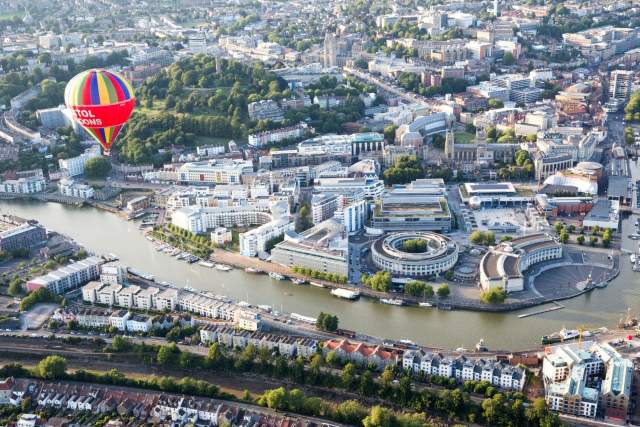 Hot air balloons fly over Bristol harbourside in Bristol, England.