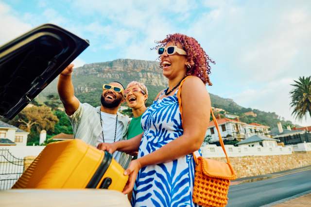 A group of friends smile on a trip