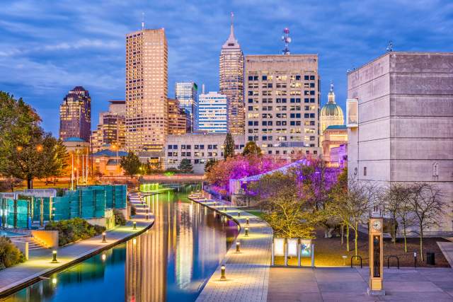 A walkway along the water in downtown Indianapolis at night.