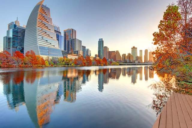 The Austin, Texas skyline visible at dusk from across a body of water.