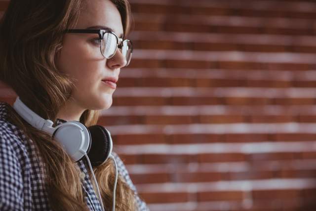 Woman with headphones around neck