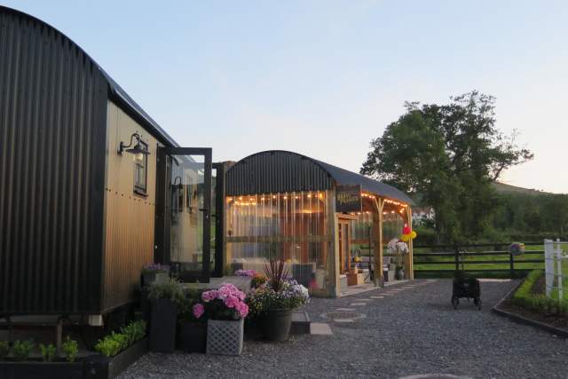 Fairy-lit glamping accommodation at sunset in Fermanagh, Northern Ireland