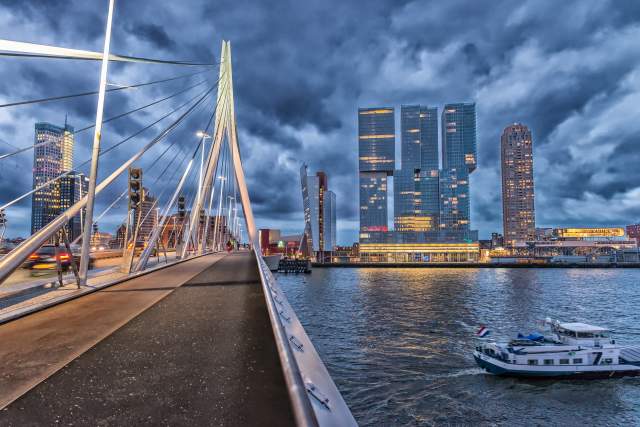 A view of portions of the Rotterdam skyline from a pedestrian bridge.