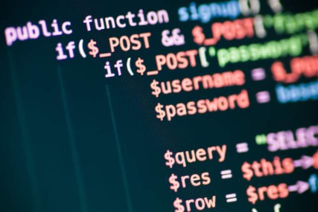 Colorful PHP code displaying POST data, username, password and database query variables on a dark screen.