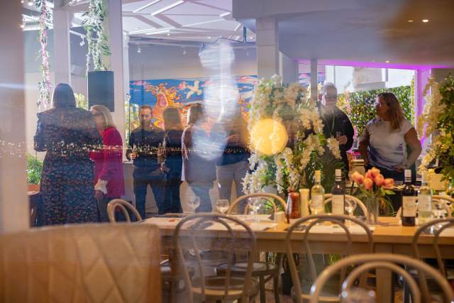 A group of people having conversation during the EMEA Summit 2025 awards reception.