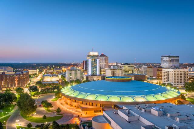 An arena in Wichita, Kansas lit up at dusk.